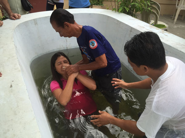  newly baptised husband baptising his wife